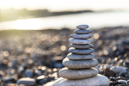Pyramid of gray pebble stones on the beach of Turkey at sunrise. Zen concept, relaxation. calmness, balanceの写真素材