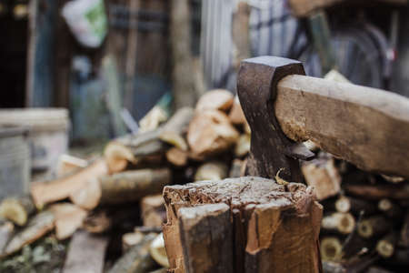 Big ax with chopped woods blurred on backgroundの写真素材
