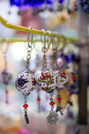 atmospheric local souvenir markets. Big Turkish Bazaar. Handmade souvenirs in the street market. Souvenirs: souvenir keychains, keychain from the evil eye, elephant, dolphin.の写真素材