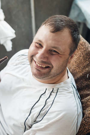happy caucasian white young man smoking hookah and blowing smokeの写真素材