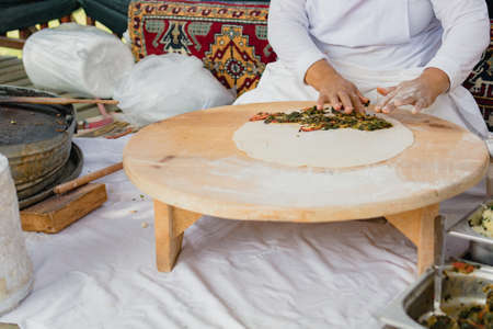 A woman prepares Turkish cakes in a hotel restaurant in Turkeyの写真素材