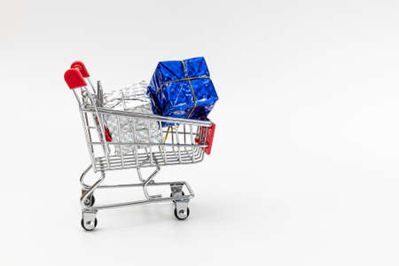 Grocery cart with New Year's holiday gifts on a white isolated plain background. Flat lay. Save the space. Postcard Template.の写真素材
