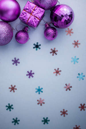 Christmas holidays composition, top view pink-purple-violet Christmas decorations on white-blue background with copy space for text. Flat lay. Winter, postcard template.の写真素材