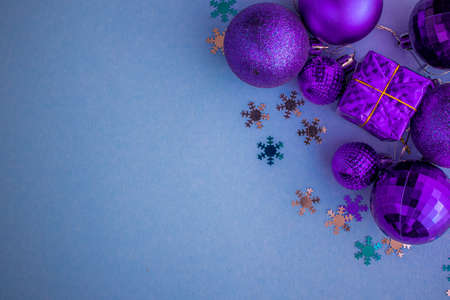 Christmas holidays composition, top view pink-purple-violet Christmas decorations on white-blue background with copy space for text. Flat lay. Winter, postcard template.の写真素材