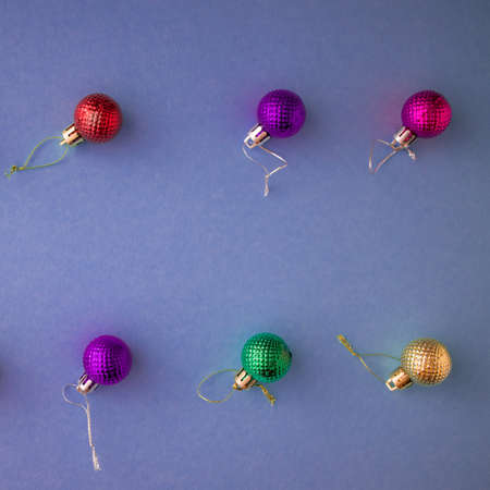 Christmas holidays composition, top view colored Christmas decorations on a purple-lilac background with copy space for text. Flat lay. Winter, postcard template.の写真素材