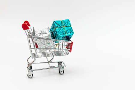 Grocery cart with New Year's holiday gifts on a white isolated plain background. Flat lay. Save the space. Postcard Template.の写真素材