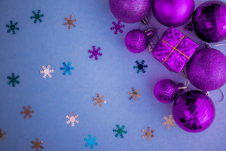 Christmas holidays composition, top view pink-purple-violet Christmas decorations on white-blue background with copy space for text. Flat lay. Winter, postcard template.の写真素材