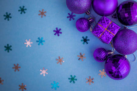 Christmas holidays composition, top view pink-purple-violet Christmas decorations on white-blue background with copy space for text. Flat lay. Winter, postcard template.の写真素材