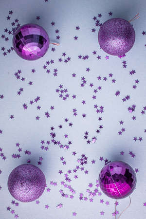 Christmas holidays composition, top view pink-purple-violet Christmas decorations on white-blue background with copy space for text. Flat lay. Winter, postcard template.の写真素材