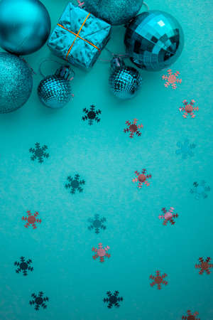 Christmas holidays composition, top view blue-aquamarine Christmas decorations on a green-blue background with copy space for text. Flat lay. Winter, postcard template.の写真素材