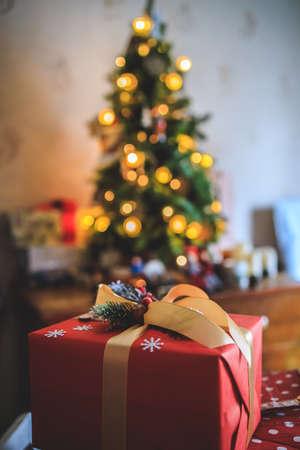 beautiful gift on a bokeh background with a Christmas tree. Copy spaceの写真素材