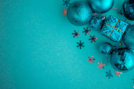 Christmas holidays composition, top view blue-aquamarine Christmas decorations on a green-blue background with copy space for text. Flat lay. Winter, postcard template.の写真素材