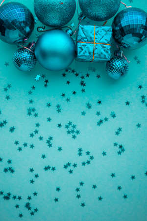 Christmas holidays composition, top view blue-aquamarine Christmas decorations on a green-blue background with copy space for text. Flat lay. Winter, postcard template.の写真素材