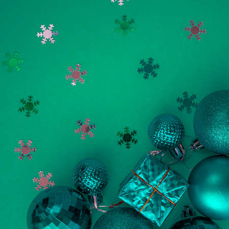 Christmas holidays composition, top view colored green and aquamarine Christmas decorations on green background with copy space for text. Flat lay. Winter, postcard templateの写真素材