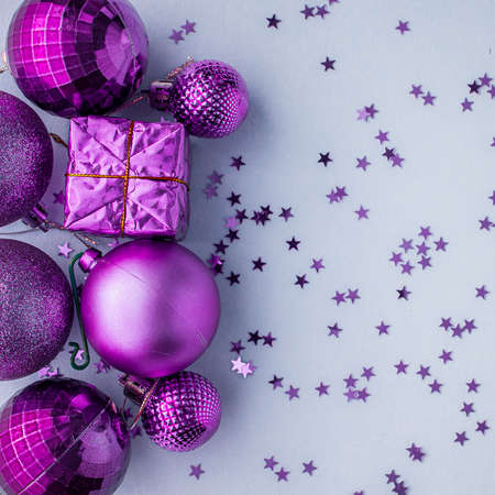 Christmas holidays composition, top view pink-purple-violet Christmas decorations on white-blue background with copy space for text. Flat lay. Winter, postcard templateの写真素材