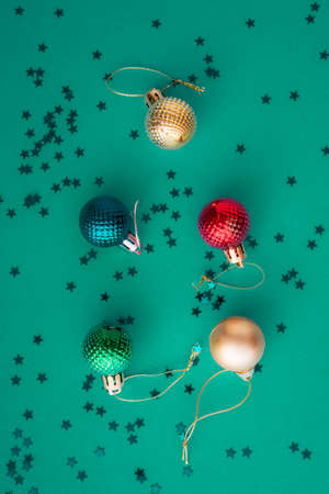 Christmas holidays composition, top view colored green and aquamarine Christmas decorations on green background with copy space for text. Flat lay. Winter, postcard templateの写真素材