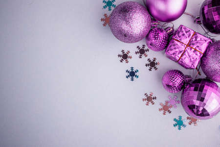 Christmas holidays composition, top view pink-purple-violet Christmas decorations on white-blue background with copy space for text. Flat lay. Winter, postcard templateの写真素材