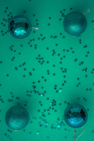 Christmas holidays composition, top view colored green and aquamarine Christmas decorations on green background with copy space for text. Flat lay. Winter, postcard templateの写真素材