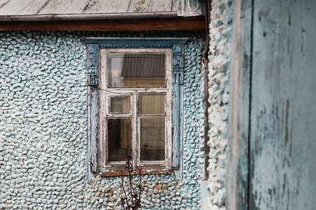 old wooden window on an old stone blue houseの写真素材