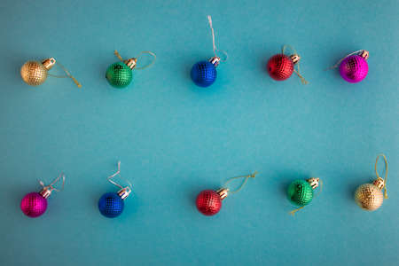 Christmas holidays composition, top view colored christmas decorations on green-blue-aquamarine background with copy space for text. Flat lay. Winter, postcard templateの写真素材