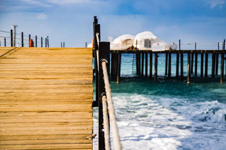 wooden pier in the mediterranean sea on a clear sunny day, view from below, perspective.の写真素材
