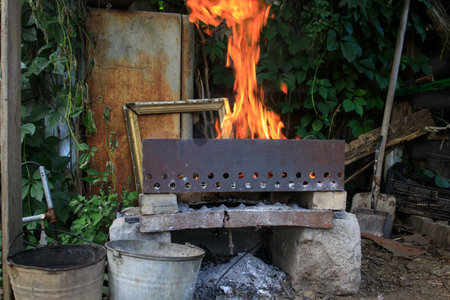 a fire in an old brazier in a dump of things.の写真素材