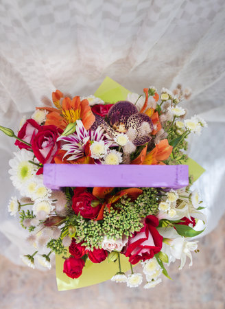beautiful bright bouquet in a purple basket on a white background, copy spaceの写真素材