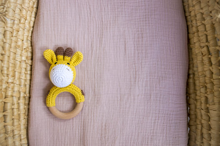 in a basket natural wooden knitted toys for a newborn. View from aboveの写真素材