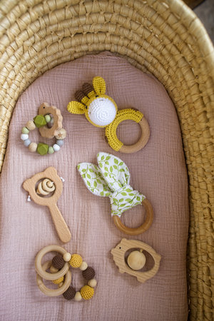 in a basket natural wooden knitted toys for a newborn. View from aboveの写真素材