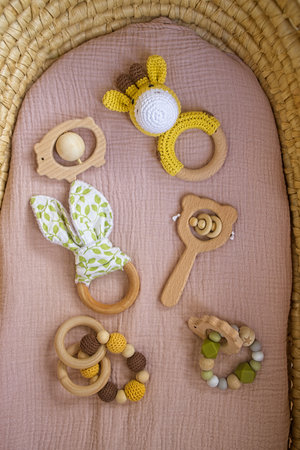 in a basket natural wooden knitted toys for a newborn. View from aboveの写真素材