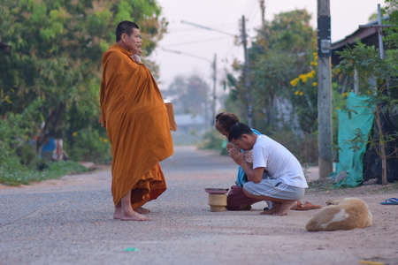 Kalasin, Thailand - February 22, 2021 : People were waiting to give food to the monks in the morning...
