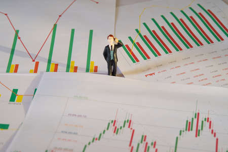 miniature business people and business financial eps chart data on white paper, business and financial analysis conceptの写真素材