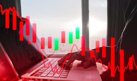 stock price down in bearlish market concept, stock trader using laptop for trading, stock graph chart with fibonacci indicator, macd indicator in panic bearlish markets on red backgroundの写真素材