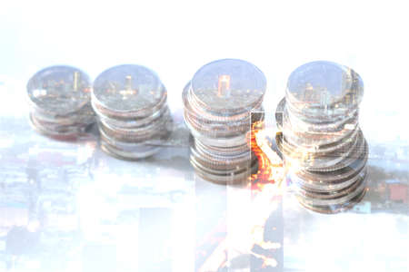 financial growth concept, double exposure of row of coins and cityscape at nigth with diagramの写真素材