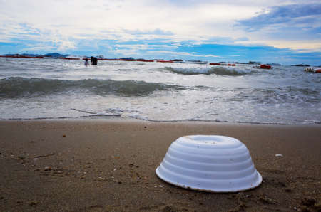 pollution problem concept, Garbage on beach and people in the sea