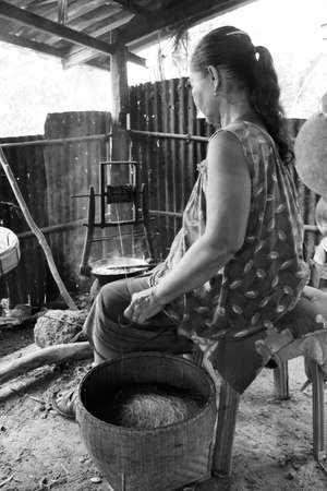 old woman working about manufacture she pull thread of silk の写真素材