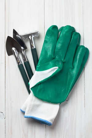 garden tools and gloves on wooden tableの写真素材