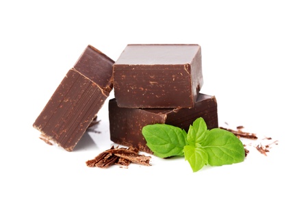Closeup  of chocolate parts and mint leaves on white background