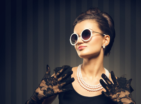 portrait of beautiful brunette woman wering pearl  jewelry  retro styleの写真素材