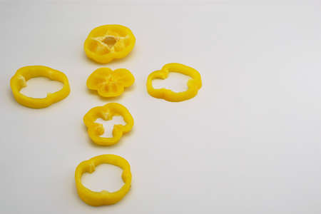 isolated slightly cut yellow sweet pepper adjust as cross signの写真素材