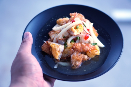 Thai spicy fried egg  salad on dishの写真素材