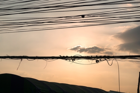 sunset with the disarrangement of electric wireの写真素材