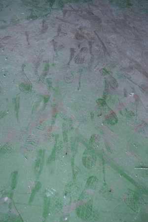 mix of foot print on the dirty green floorの写真素材