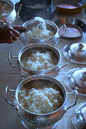 put rice for offerings in a Buddhist monk's alms bowlの写真素材