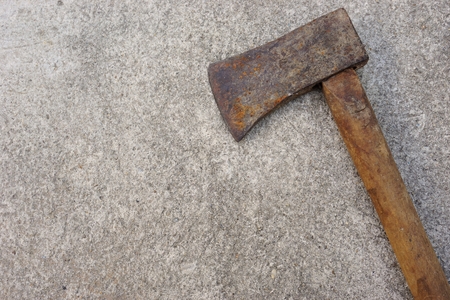 iron axe with wood handle on the concrete backgroundの写真素材