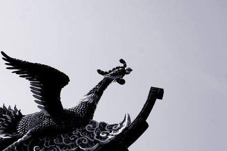 black and white peacock sculpture on the roof topの写真素材