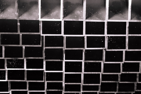 stack of black and white metal square tube