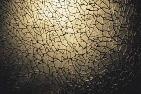 abstract crack of tempered glass on the stainless steel plate dye in goldenの写真素材