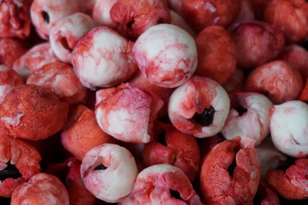 group of pink and red Manila tamarind fruit in the bowlの写真素材