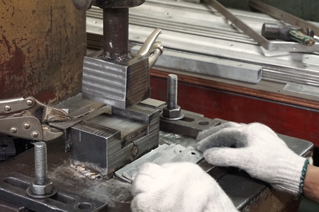 worker work on sheet metal stamping process in factoryの写真素材